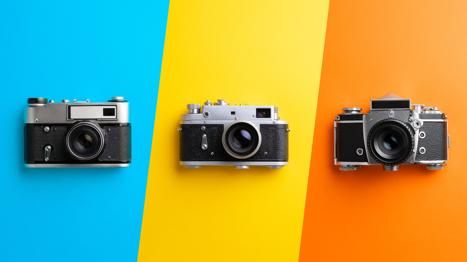 three cameras on a colorful background